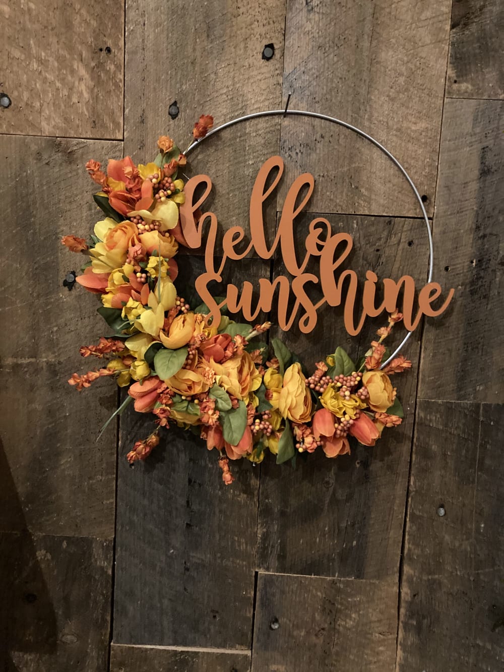An orange hoop wreath that says hello sunshine